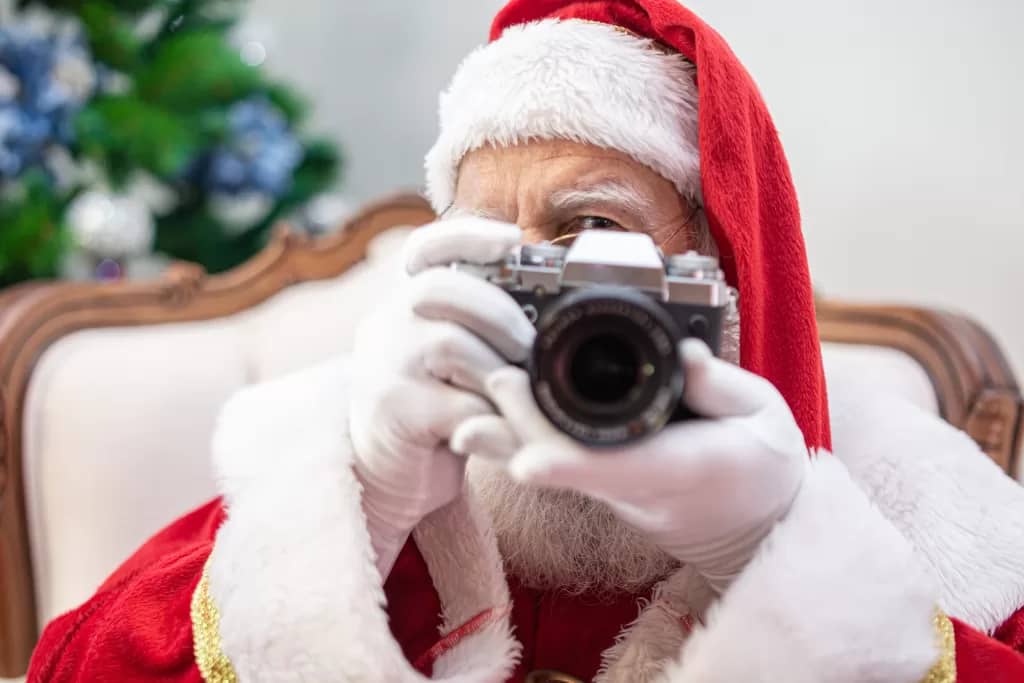 Santa St. Clickolas with a camera
