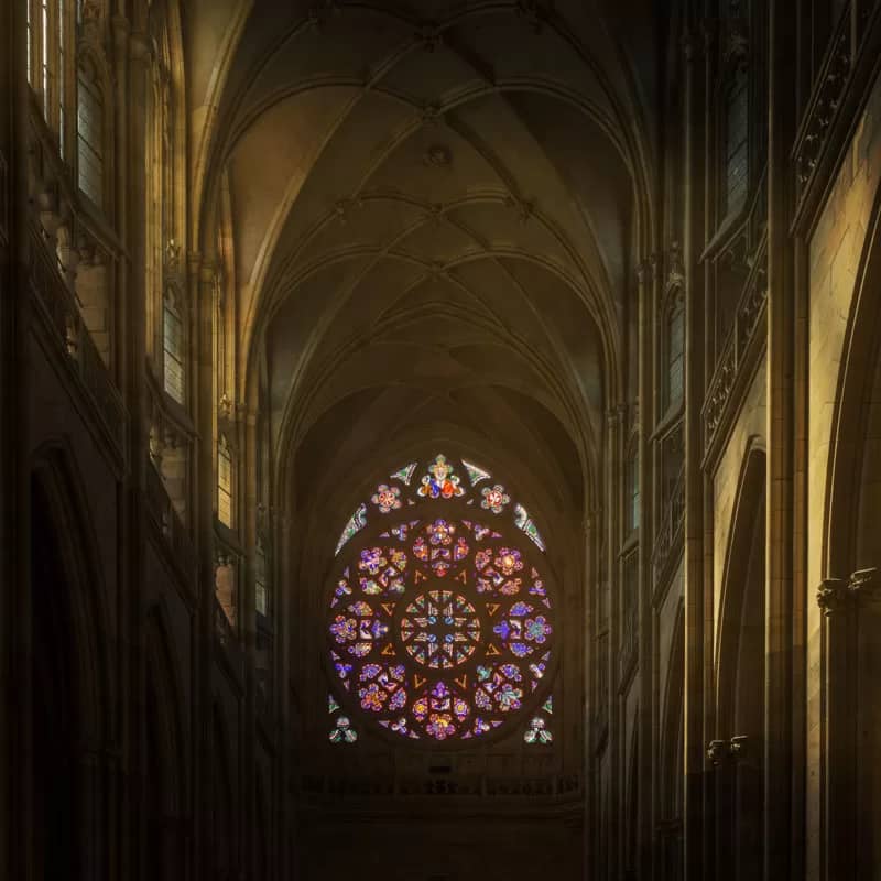 Light streaming through a stained glass window at St. Vitus Cathedral